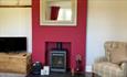 Living room with wood burner at The Old Abbey Farmhouse Holiday Cottage at Quarr Abbey, self-catering, Isle of Wight