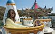 Lady and child riding the teacups at The Needles Landmark Attraction, Alum Bay, Isle of Wight, Things to Do