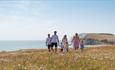 Group of people walking along the cliff at Freshwater Bay, Isle of Wight - copyright: visitisleofwight.co.uk