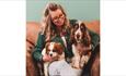 Suzanne Wright with two dogs on her lap sitting on the sofa, Wright Zone Doggy Care, dog friendly, dog day care, Isle of Wight