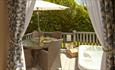 View of balcony with hot tub and outside dining area from inside of lodge at St Helens Holiday Resort, Isle of Wight, Self Catering