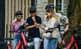 Group of people hiring electric bikes and electric scooters from Voi, getting around, Isle of Wight, bike hire, cycling