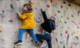 Two children on the climbing wall at Tapnell Farm Park, Isle of Wight, attraction, family fun, activities