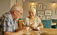 Couple sitting in dining area at The Bay Colwell Holiday Resort, Isle of Wight, Self Catering