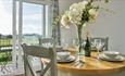 Dining table and chairs inside a property, Island Holiday Homes, self catering, Isle of Wight