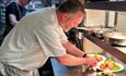 Chef serving food at The Woodmans Arms, Wootton, Isle of Wight, country pub, local produce, food & drink