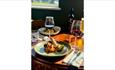 Dish and glasses of wine at The Sun Inn Calbourne, Isle of Wight, pub, eat and drink, local produce