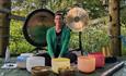 Mel sitting with bowls and gongs to provide a sound bath in the forest on the Isle of Wight, wellness, retreat, activity, health and wellbeing, sanctu