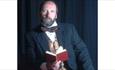 Gerald Dickens holding a book, Dickens House Party Weekend at The Royal Hotel, Ventnor, Isle of Wight, event, what's on