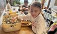 Child looking at sea shells, Island Craftworks, art workshop, family, children activities, adult activities, Isle of Wight
