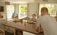 Family enjoying open plan kitchen and living area in self catering accommodation at St Helens Holiday Resort, Isle of Wight