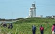 Group of walkers walking past St Catherine's Lighthouse, Isle of Wight Walking Festival, Spring event, Autumn event, what's on, things to do