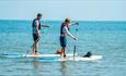 Couple paddleboarding on the water, SupDog kayak and paddleboard hire, Colwell beach, Isle of Wight, sports activities, water sports