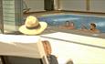 View of inside swimming pool from chairs outside at The Bay Colwell Holiday Resort, Isle of Wight, Self Catering