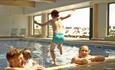 Family in inside swimming pool at The Bay Colwell Holiday Resort, Isle of Wight, Self Catering