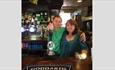 The owners standing at the bar in The Waverley Inn, Carisbrooke, B&B