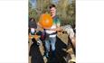 Man holding a large pumpkin at the Pumpkin Patch event at Westover Farm, family friendly, children's activities, Halloween event, what's on, Isle of W