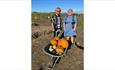 Couple standing next to a variety of pumpkins in a wheelbarrow at the Pumpkin Patch event at Westover Farm, family friendly, children's activities, Ha