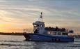 Kraken catamaran sailing on the Solent with the sun setting in the background, Quay 2 Quay, Isle of Wight, ferry travel, Yarmouth