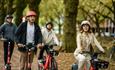 Group of people hiring electric bikes and electric scooters from Voi, getting around, Isle of Wight, bike hire, cycling