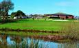 Shanklin & Sandown Golf Club's course and lake with the clubhouse in the background, Isle of Wight, activity