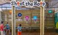 Children playing the Shoot the Hoop game in the barn at Tapnell Farm Park, Isle of Wight, attraction, family fun, activities