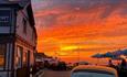 Outside view of The Old Fort with a sunset over the sea, Seaview, Isle of Wight, food & drink