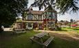 Outside view of The Cedars with seating area, Wootton, pub