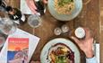 Two dishes and bottle of wine on a table at The Old Fort, Seaview, Isle of Wight, food & drink