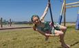 Girl on the outside zip wire at Tapnell Farm Park, Isle of Wight, attraction, family fun, activities