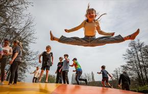 Girl bouncing on the pillow at Robin Hill Adventure Park, Newport, Isle of Wight, attraction, family, children activities