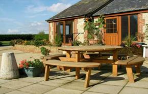 Outside view of Rose Cottage with outdoor picnic table, Atherfield Green Farm Holiday Cottages, Chale, Self Catering