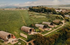 Aerial view of Tapnell Farm with exterior view of modulogs, Tom's Eco Lodge, self-catering, West Wight, Isle of Wight