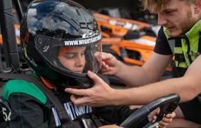 Man helping child with helmet before karting at Wight Karting, Ryde, Children's Events, junior track days
