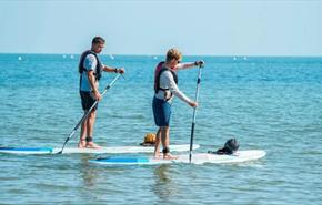 Couple paddleboarding on the water, SupDog kayak and paddleboard hire, Colwell beach, Isle of Wight, sports activities, water sports