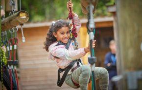 Girl on zip wire at PGL Little Canada, Isle of Wight