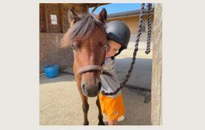 Child hugging horse at Island Riding Centre on the Isle of Wight