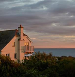 Outside view of Flackstead with the sun setting behind, property with Classic Cottages, Isle of Wight, self catering, accommodation, luxury, cottages