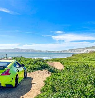 Isle of Wight, Things to do, Takeover, Car enthusiasts, County Showground, image of car overlooking bay from Compton Bay Carpark