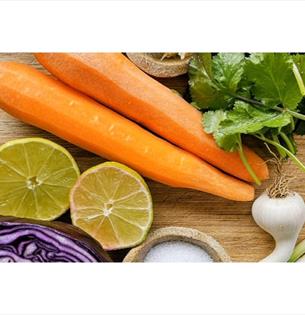 Isle of Wight, things to do, Garlic Farm, Workshop, Veg on a wood chopping board.