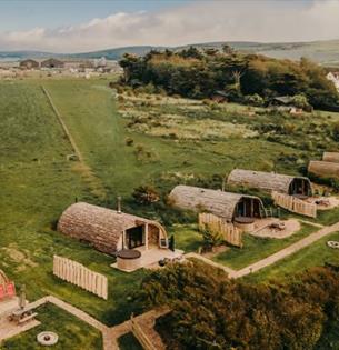 Aerial view of Tapnell Farm with exterior view of modulogs, Tom's Eco Lodge, self-catering, West Wight, Isle of Wight