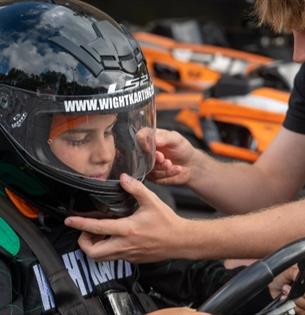 Man helping child with helmet before karting at Wight Karting, Ryde, Children's Events, junior track days