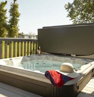 Hot tub on balcony of lodge at St Helens Holiday Resort, Isle of Wight, Self Catering