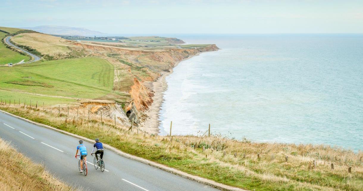 Cyclists riding on the Military Road with sea views