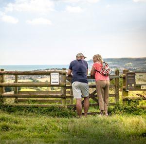 Couple at Brading downs enjoying the sea and countryside views