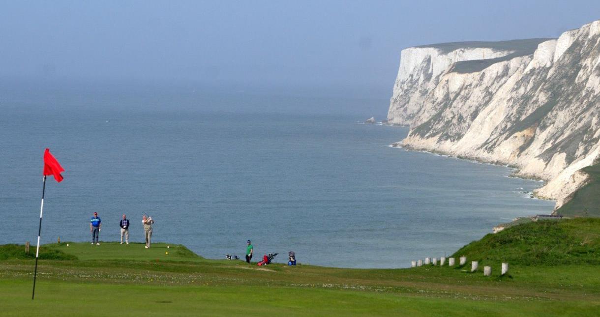 Group of people playing golf at Freshwater Bay Golf Club on the Isle of Wight