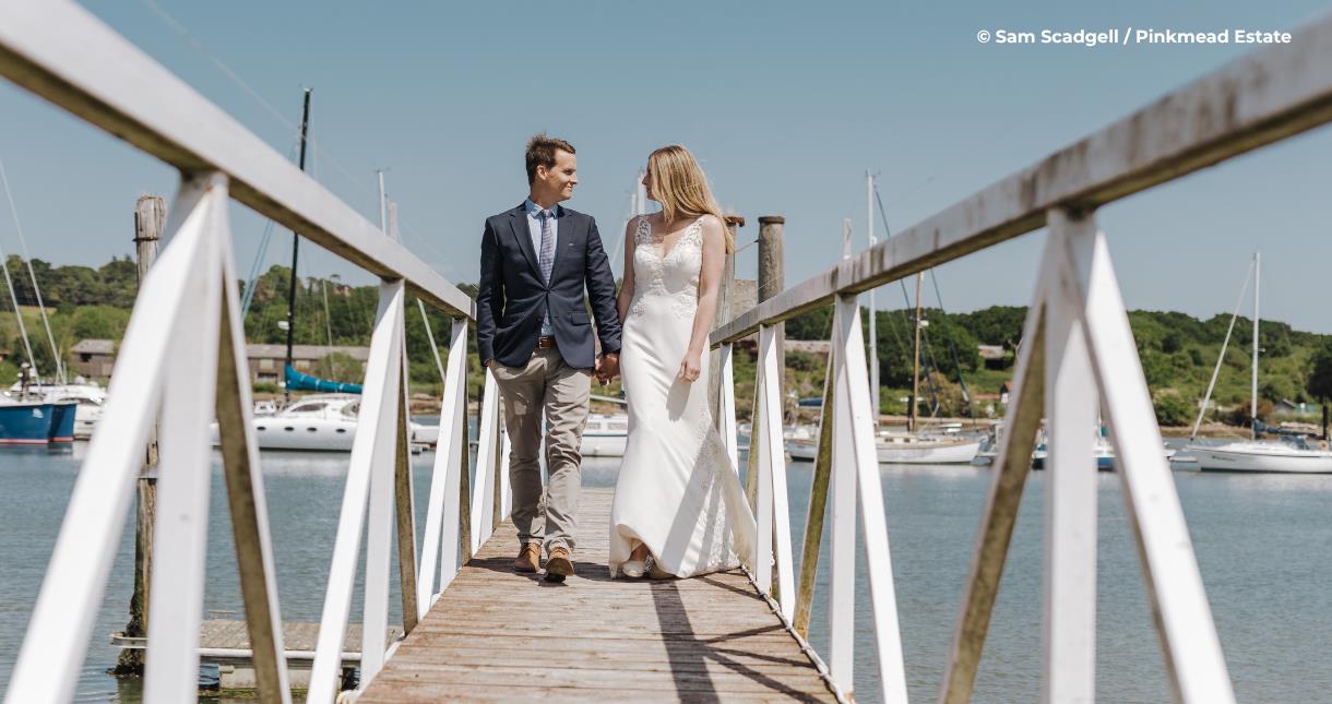 Bride and group walking on the jetty at Pinkmead Estate on the Isle of Wight