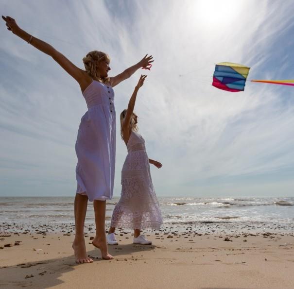 Ladies flying a kite on Compton beach