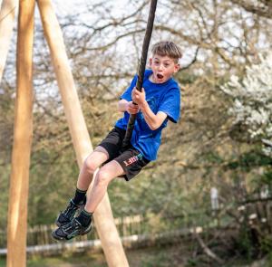 Boy on the zip wire at the Botswana Play Area at Robin Hill Adventure Park on the Isle of Wight