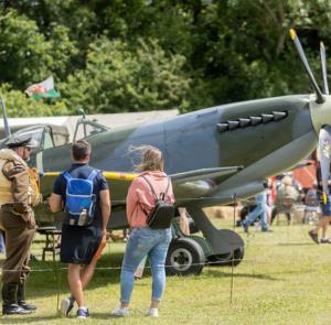 People viewing an historic plane at The 1940s Experience at the Isle of Wight Steam Railway